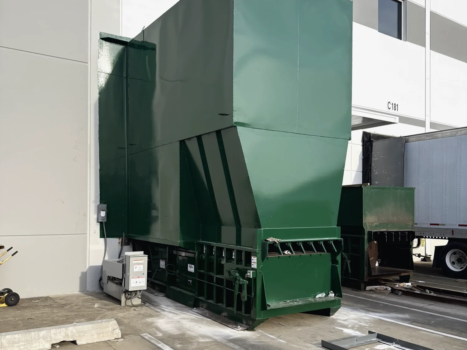 A 4-yard stationary compactor under a 14-foot enclosure fabricated by Norton