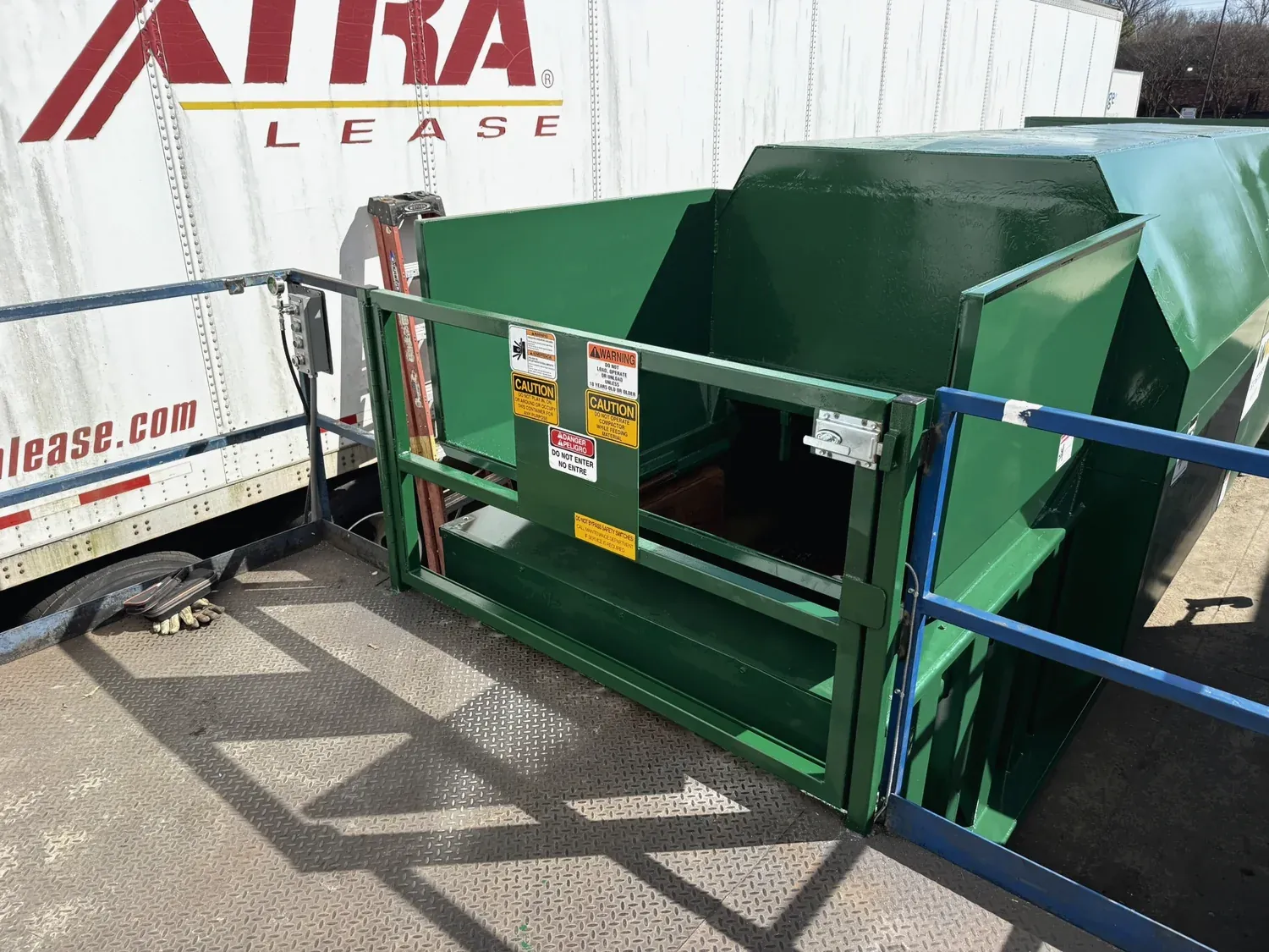 A rear feed hopper with gate fabricated by Norton