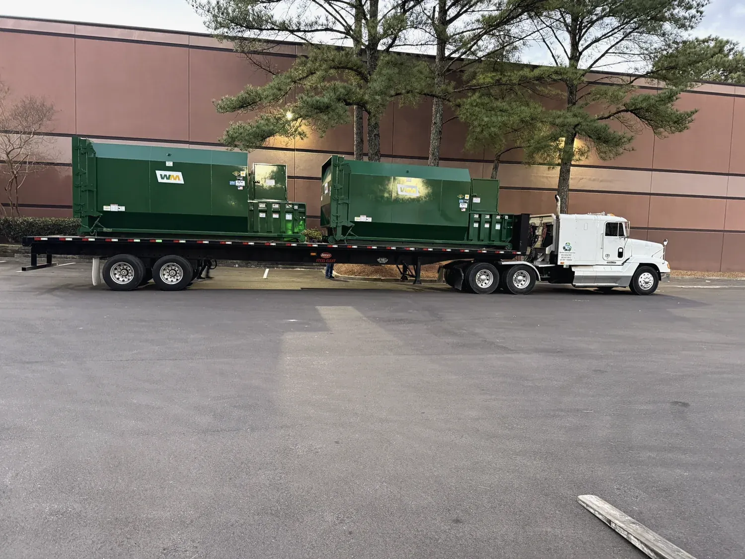 Compactors loaded on a flatbed for delivery