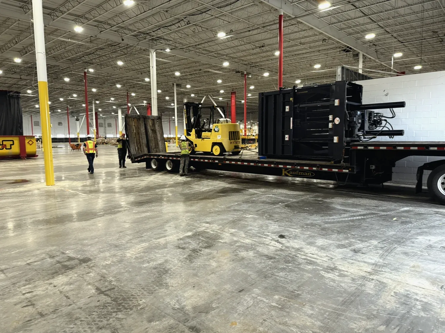 Machinery strapped to a flatbed trailer for transport