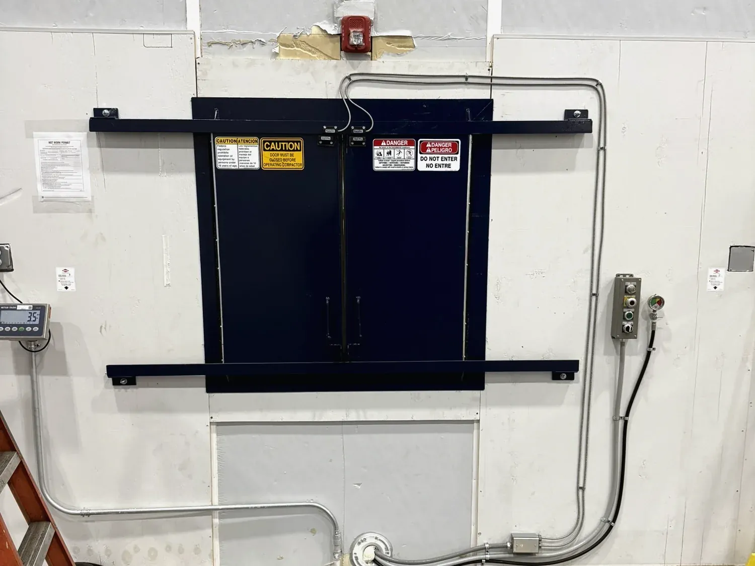 A dual sliding through-wall door fabricated by Norton