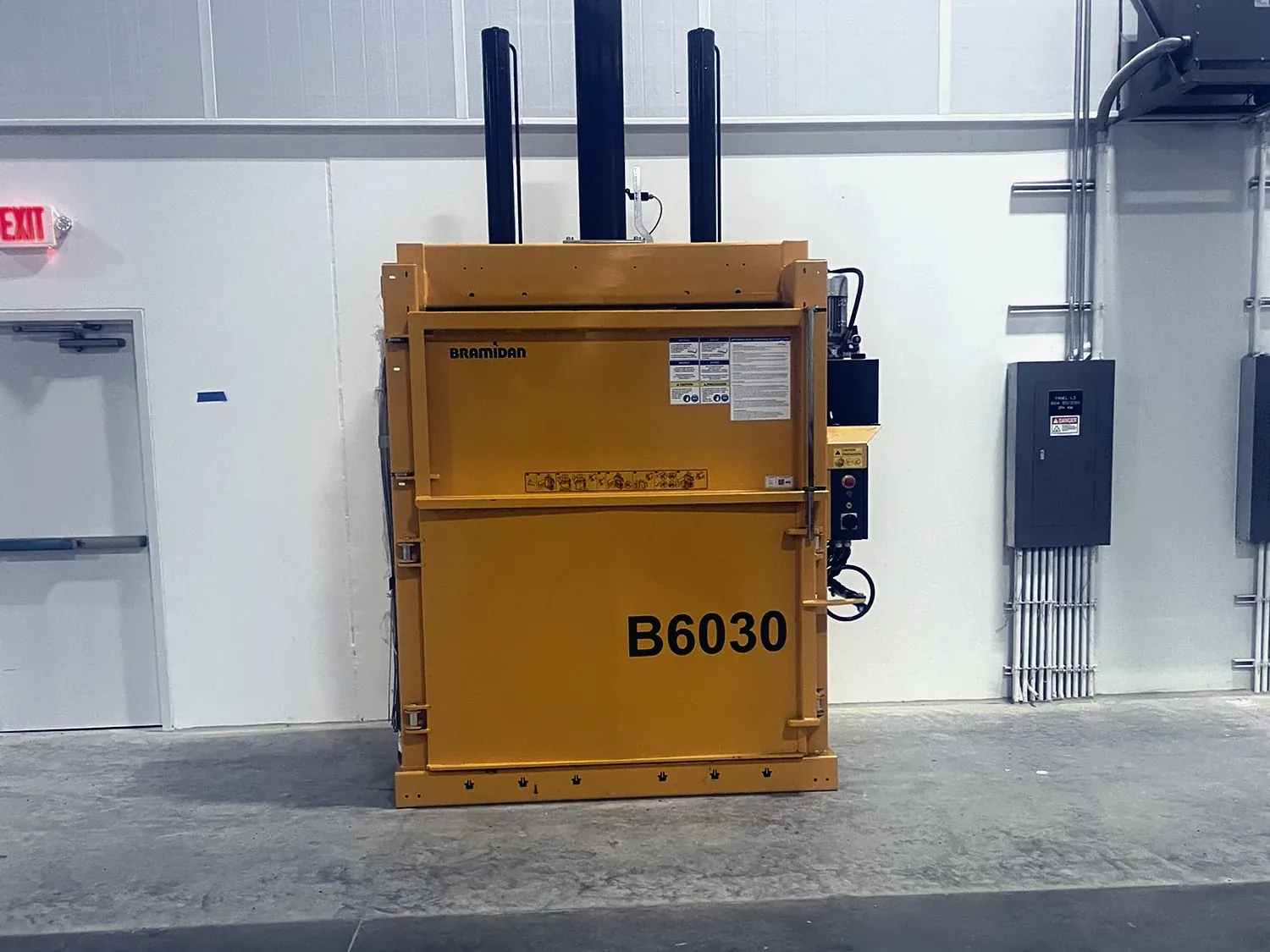 A used vertical baler on the floor